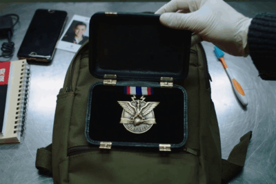 They rifled through a 17-year-old’s backpack at the airport—then froze when they saw a medal found in no database—the single name she uttered got the room sealed on the spot.